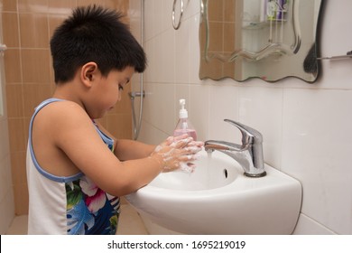 Child Washing Hand With Soap In Wash Basin.Prevention Of Infection During The Outbreak Of The Covid-19 Virus.Healthy Lifestyle Concept.