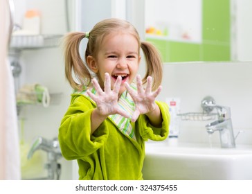 Child Washing Hands And Showing Soapy Palms