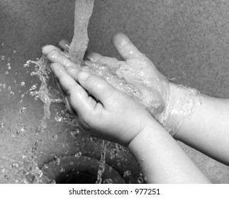 Child Washing Hands In Sink