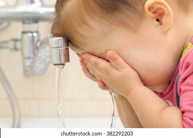 Child Washing Her Face. Clean Tap Water. Baby Wash