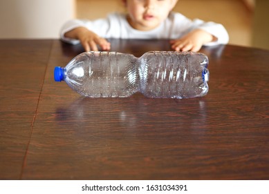 Child Watching On A Plastic Bottle. Concept Of Awareness Of The Plastic Pollution World, The Future For Our Children .