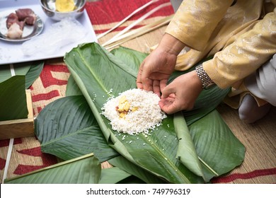 Child wear traditional dress Ao Dai learning to make Chung cake by hands closeup, Chung cake is the most important traditional Vietnamese lunar New Year (Tet) food.