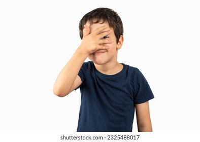 Child with wearing blue t-shirt standing over isolated white background peeking in shock covering face and eyes with hand, looking through fingers with embarrassed expression - Powered by Shutterstock