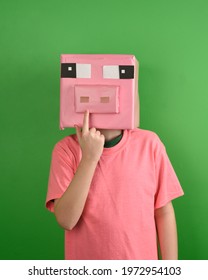 A Child Is Wearing A Cardbord Pig Mask Made Out Of Paper For A Creative Diy Craft Costume Concept.