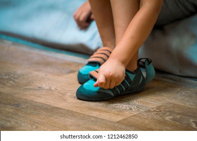 The child is wearing climbing shoes. The boy is getting ready for training. Baby feet close up. Special shoes for training. - Shutterstock ID 1212462850