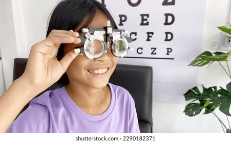 Child wearing eyeglasses for medical eye test in clinic , eye exam, eye test concept, kid eye test - Powered by Shutterstock