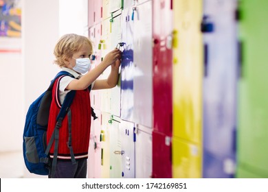 Child wearing face mask during corona virus and flu outbreak. Disease and illness protection for kids. Surgical masks for coronavirus prevention. School kid coughing. Little boy going to school. - Powered by Shutterstock