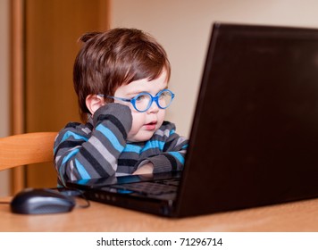 Child Wearing Glasses Using A Computer