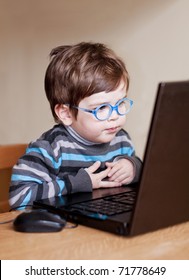 Child Wearing Glasses Using A Computer