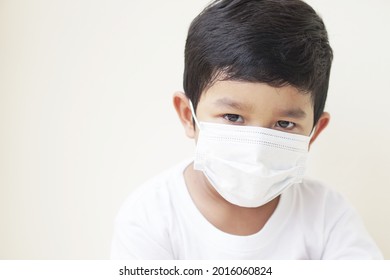 Child Wearing Protective Medical Mask To Prevent Virus Corona Or PM 2.5 Concept. Portrait Of Cute Little Asian 2 -3 Years Old Toddler Baby Boy So Sad Face.                               