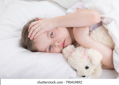 Child In A White Bed Complains Of A Headache