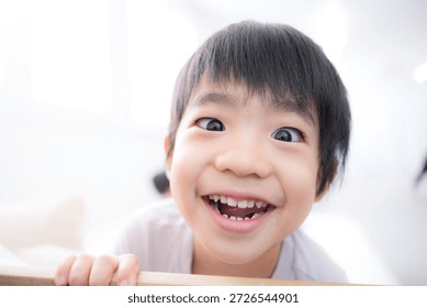 A child whose smile was captured by the camera A close-up image of a joyful, adorable, childlike, innocent, hearty laugh