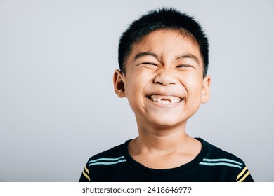 Child wide smile reveals gap from missing upper tooth. Dental development isolated on white. Tooth loss joyful growth tooth fairy moment. Children show teeth new gap, dentist problems - Powered by Shutterstock