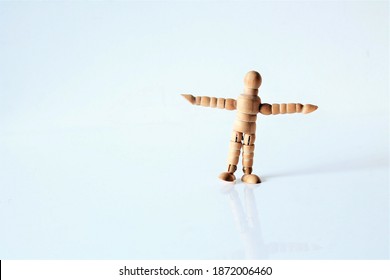 child wood figue balancing on one leg