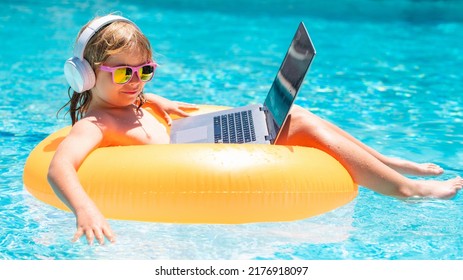 Child Working On Laptop Computer At Poolside Swimming Pool. Summer Business And Online Technology.