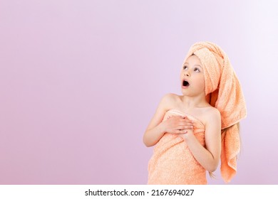 A Child Wrapped In A Towel Looks At The Advertisement Next To Him In Surprise. Space For Copying.