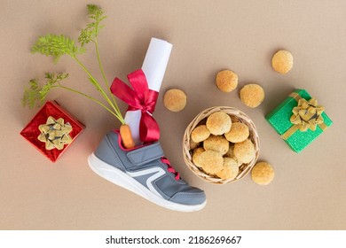 child writing letter on traditional Dutch holiday Sinterklaas in Europe, Netherlands, Belgium. girl put in in boot, shoe carrot for Santa horse, gift, pepernotin chocolate sweet cookies.  flat lay