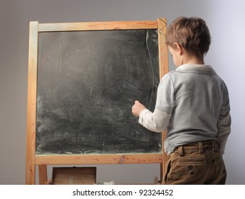 Child Writing On A Blackboard