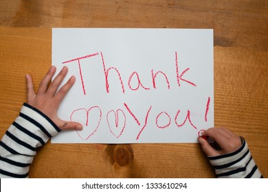 A Child Writing Thank You On Paper