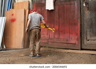 A Child With A Yellow Dog Is Digging In The Sand. The Preschooler Has Stained His Clothes. The Hyperactive Boy Is Walking In The Yard.