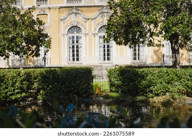 A child in a yellow jumpsuit and hat walks in a park with a fountain at Villa Durazzo in Genoa, Italy - Shutterstock ID 2261075589