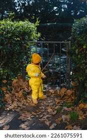 A child in a yellow jumpsuit and hat walks in a park with a fountain at Villa Durazzo in Genoa, Italy - Shutterstock ID 2261075591