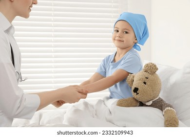 Childhood cancer. Doctor and little patient in hospital - Powered by Shutterstock