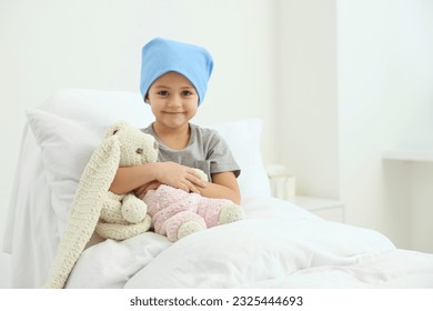 Childhood cancer. Girl with toy bunny in hospital - Powered by Shutterstock