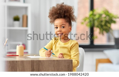 Similar – Image, Stock Photo a child sits on the wooden floor and reads a book while the sun shines on it