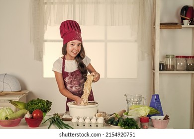 Childhood Development. Small Girl Baking In Kitchen. Kid Chef Cooking Making Dough. Child Prepare Healthy Food At Home And Wearing Cook Uniform. Housekeeping And Home Helping. Calorie And Diet