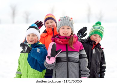 Childhood, Friendship And Season Concept - Group Of Happy Little Kids In Winter Clothes Outdoors