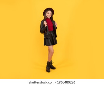 Childhood Happiness. Happy Girl In Leather Wear. Cheerful Stylish Teen Child. Kid In Hat On Yellow Background. Autumn Season Trends. Fall Seasonal Fashion. Back To School. Tween Fashion Look.