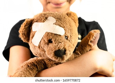 Childhood Illness And Sick Kids Concept With A Adhesive Bandages On Its Head To Cover An Injury With Copy Space 