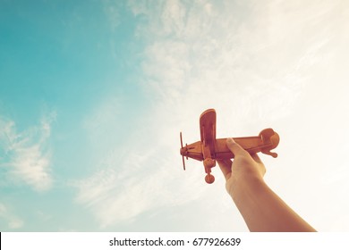 Childhood Inspiration - Hands Of Children Holding A Toy Plane And Have Dreams Wants To Be A Pilot - Vintage Filter Effect