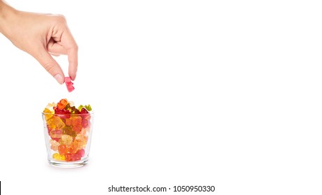 Childhood and jelly bears candies in hand isolated on white background. copy space, template.