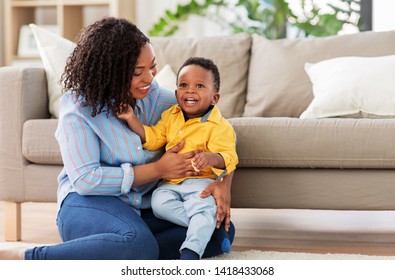 Childhood, Kids And People Concept - Happy African American Mother With Her Baby Son At Home