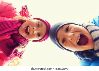 childhood, leisure, friendship, autumn and people concept - happy boy and girl faces outdoors