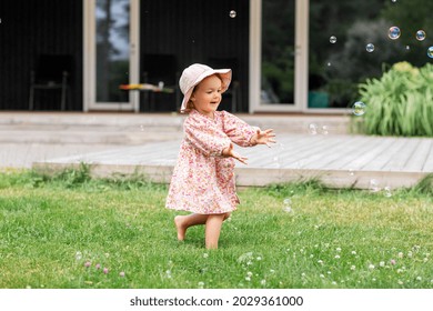 childhood, leisure and people concept - happy little baby girl playing with soap bubbles in summer - Powered by Shutterstock