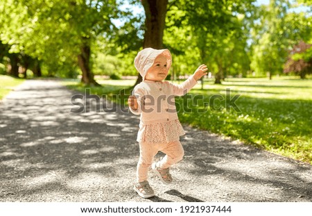 Similar – A baby girl is spoon fed with yogurt by her mother