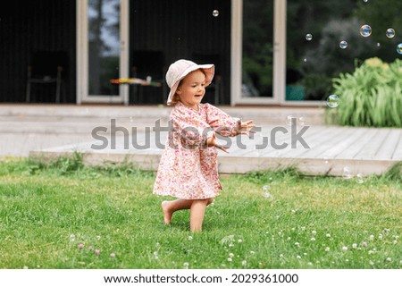 Similar – Image, Stock Photo A baby girl is spoon fed with yogurt by her mother