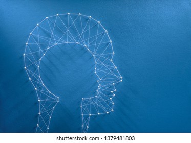 Childhood Nostalgia Concept. Network Of Pins And Threads In The Shape Of A Cut Out Child Head Inside A Man Head Symbolising The Inner Child Inside Every Human Beign.  