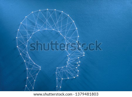 Childhood nostalgia concept. Network of pins and threads in the shape of a cut out child head inside a man head symbolising the inner child inside every human beign.   Stock photo © 