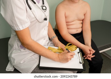 Childhood obesity problem and weight loss. Fat boy at a nutritionist appointment. Overweight boy consulting with doctor in office. Doctor examining fat boy in clinic. Doctor measuring overweight boy. - Shutterstock ID 2092243789