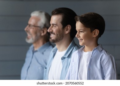 From childhood to retirement. Family dynasty of 3 different age male members stand in line together. Profiles of old age grandpa adult father and small schoolboy son grandchild look forward with smile - Shutterstock ID 2070560552