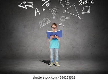 childhood, school, education, math and people concept - happy little girl in eyeglasses reading book over concrete room background with mathematical symbols