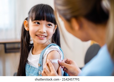 Childhood vaccination. Asian young woman doctor vaccinating little girl at home. Vaccine for covid-19 coronavirus, flu, infectious diseases. - Powered by Shutterstock