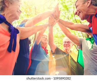 Childlike Seniors Superheroes Giving A High Five