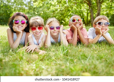 Childrean As Team On The Grass Wearing Sunglasses In Summer