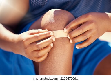 Children, Accident And Plaster With A Band Aid On The Knee Of Boy With An Injury, Wound Or Pain. Kids, Cut And Heal With The Hands Of A Male Child Outside With A Scrape, Bruise Or Injured Anatomy