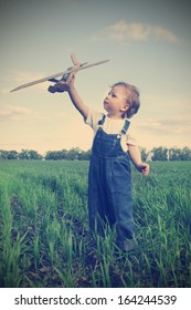 Children With Airplane Toy Outdoors